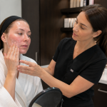 Provider explaining post laser skincare recovery routine to patient