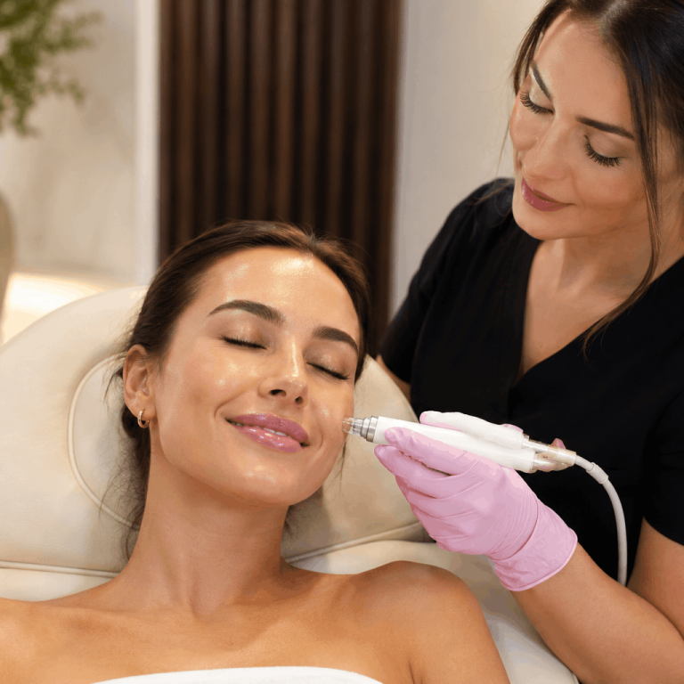 Aesthetic provider performing a hydrating facial treatment using a handheld skincare device.